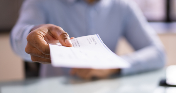African American business woman Giving Paycheck
