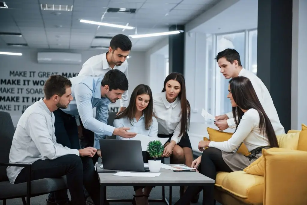 Coworker showing a document to a group of colleagues