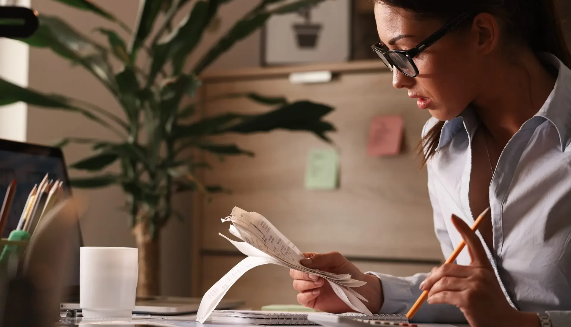 Accountant calculating payroll and tax figures in an office
